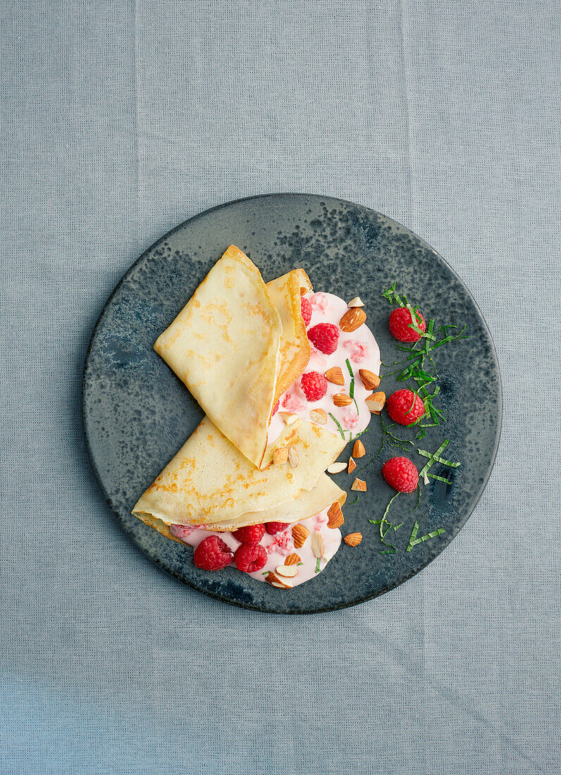 Crepes filled with raspberry cream and almonds