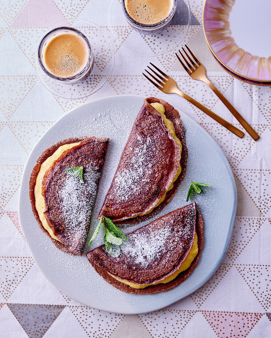 Chocolate pancakes with cream and verbena