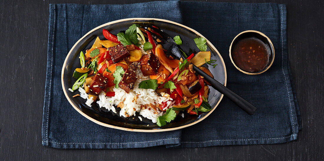 Sticky tofu with stir-fried vegetables and fresh coriander