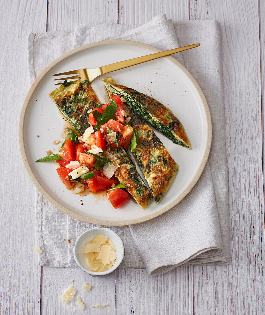 Vegetarian spinach frittata with tomatoes and parmesan cheese