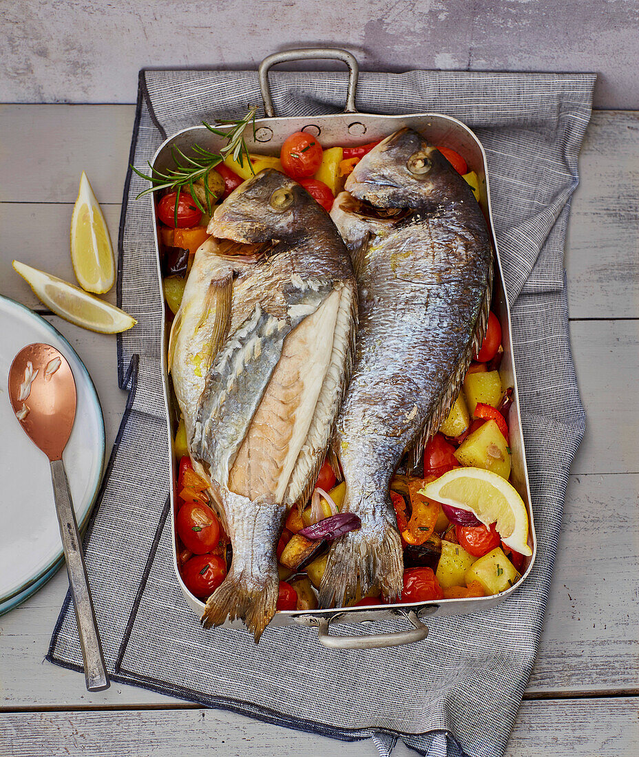 Oven-baked fish on a bed of vegetables