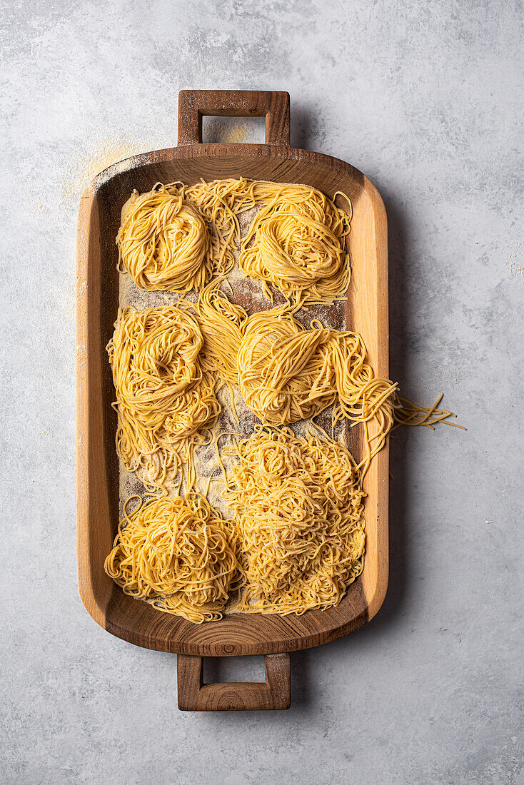 Fresh homemade pasta on a wooden tray
