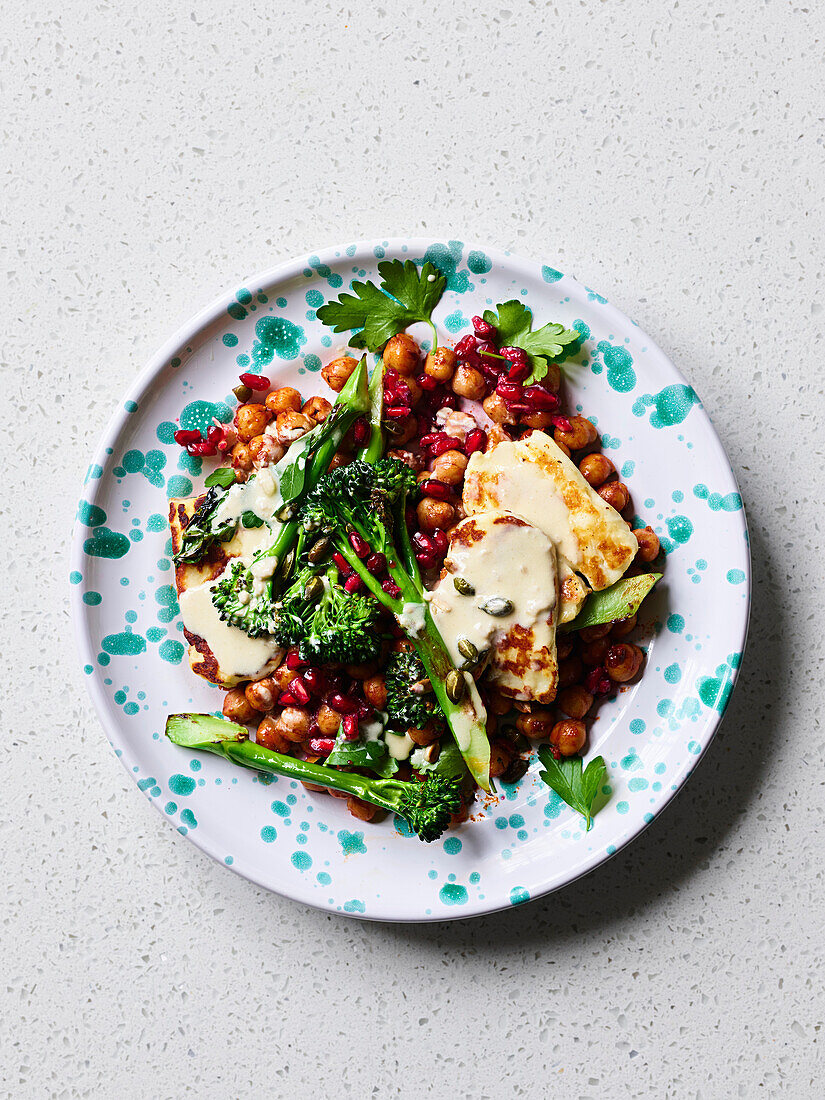 Spicy chickpeas with halloumi, broccoli and pomegranate