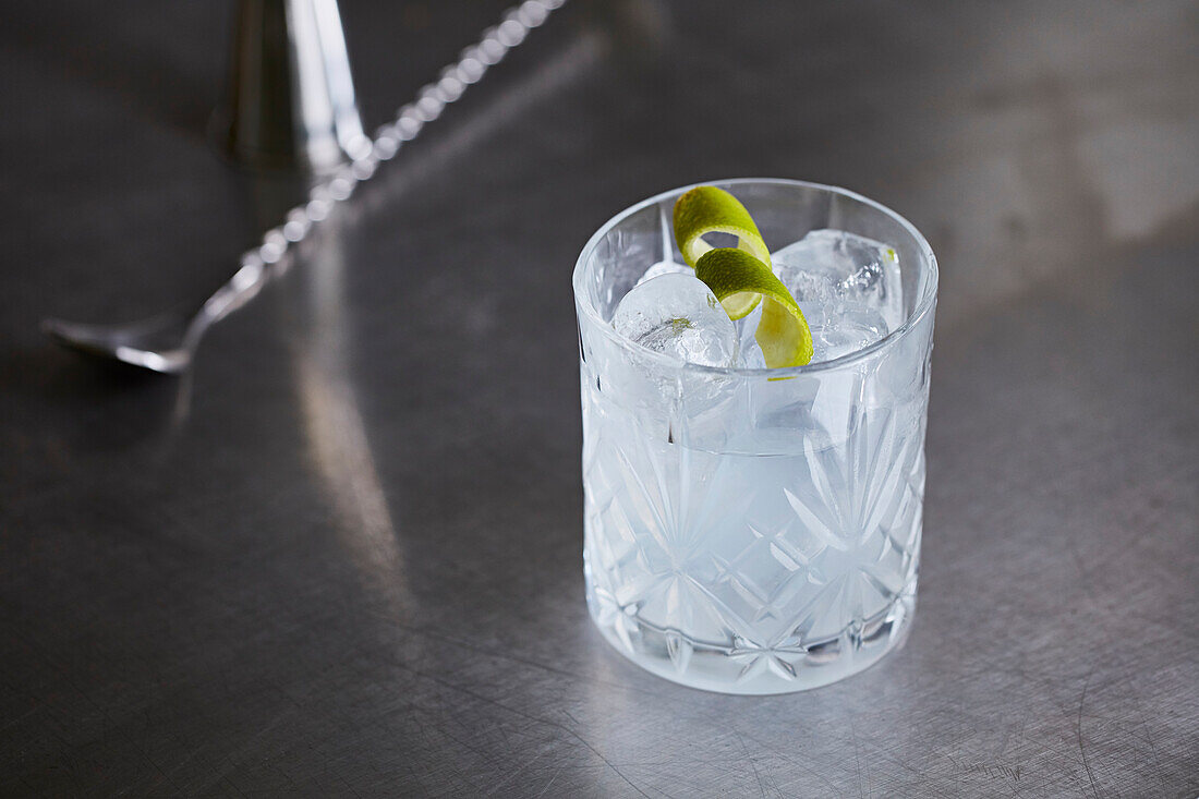 White Negroni with lime peel