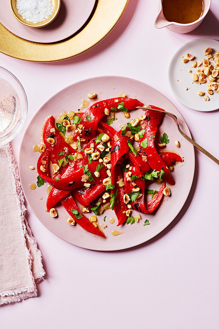 A salad of roasted red peppers and preserved lemons garnished with hazelnuts