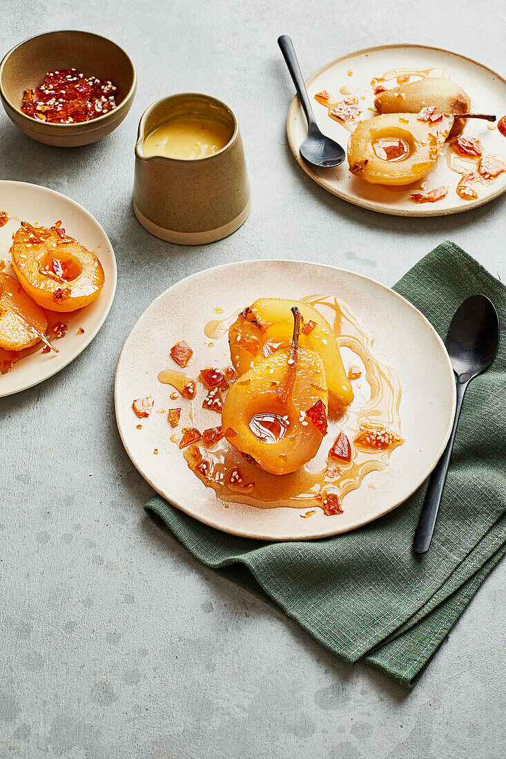 Calvados-poached pears with cardamom custard and sesame brittle