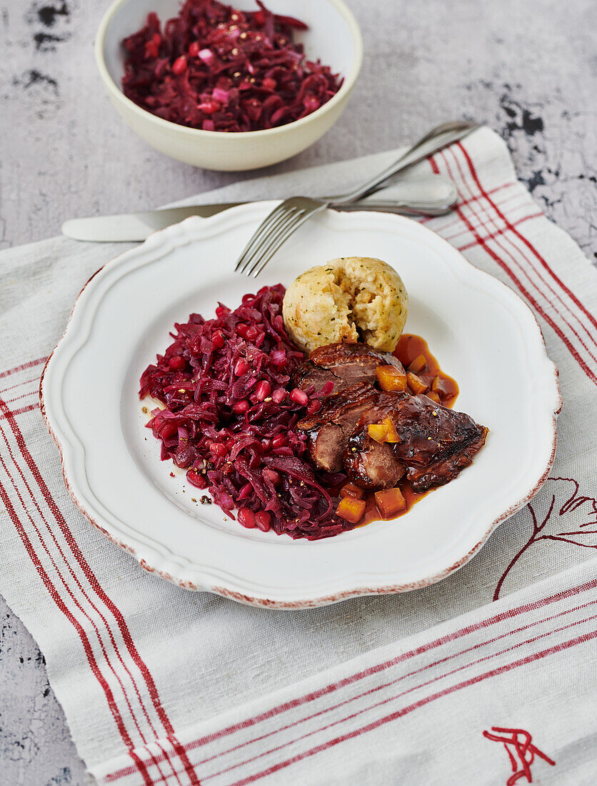 Goose breast with pomegranate, orange, red cabbage and bread dumplings