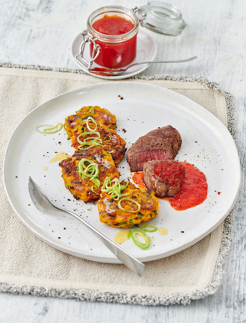 Venison steak with pepper and grape jam and leek and sweet potato biscuits