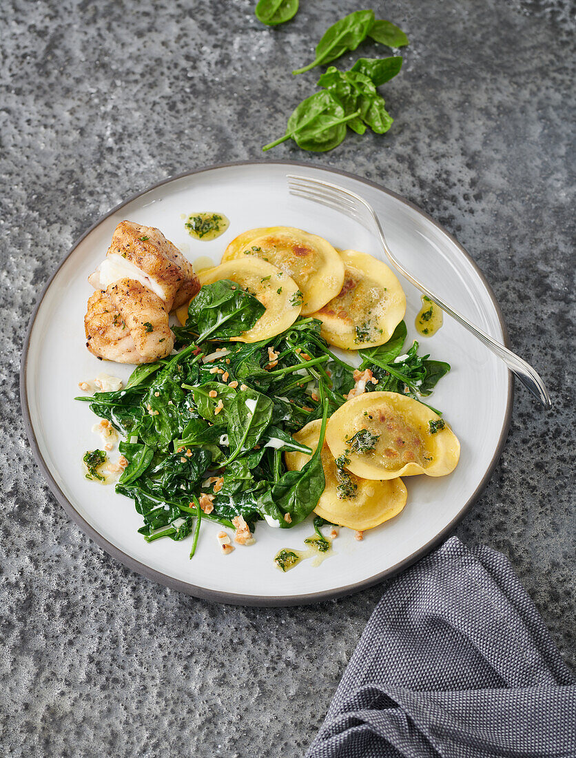 Monkfish with smoked trout ravioli and almond spinach