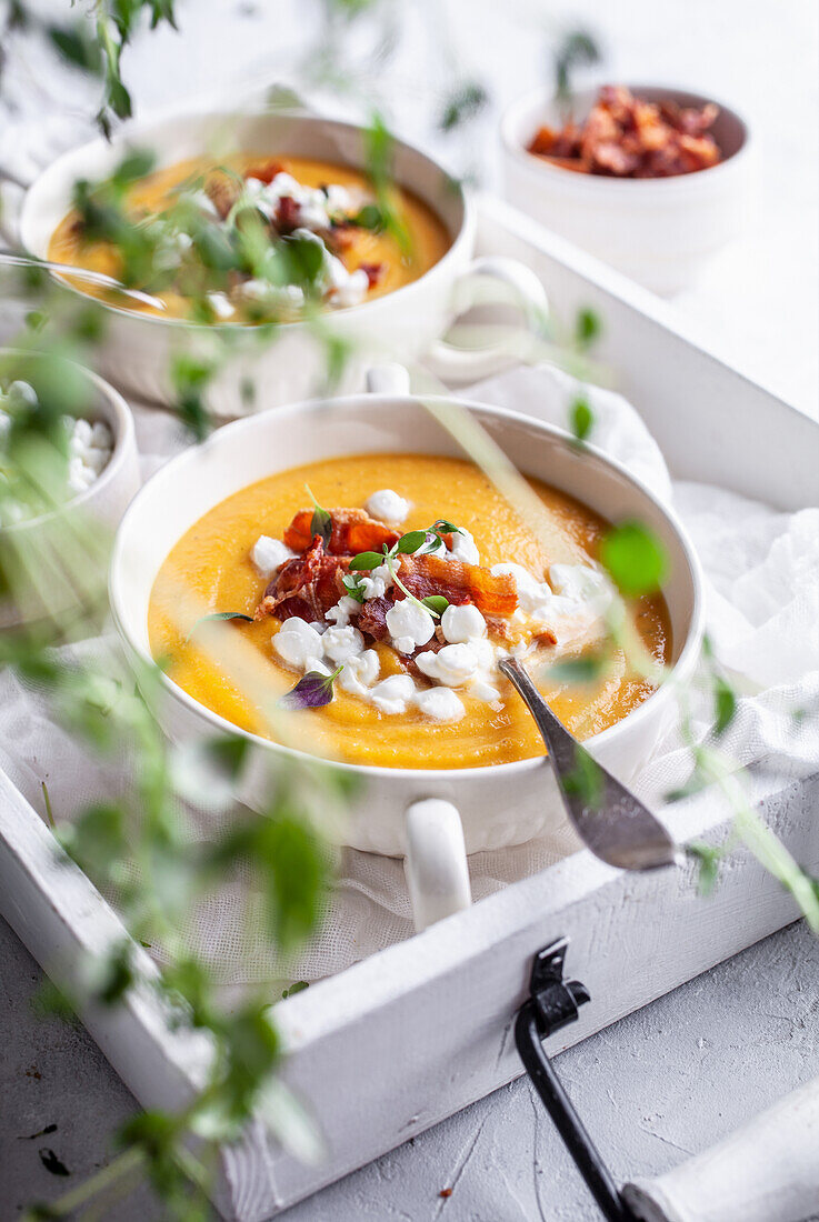 Carrot soup wit roasted bacon and cottage cheese