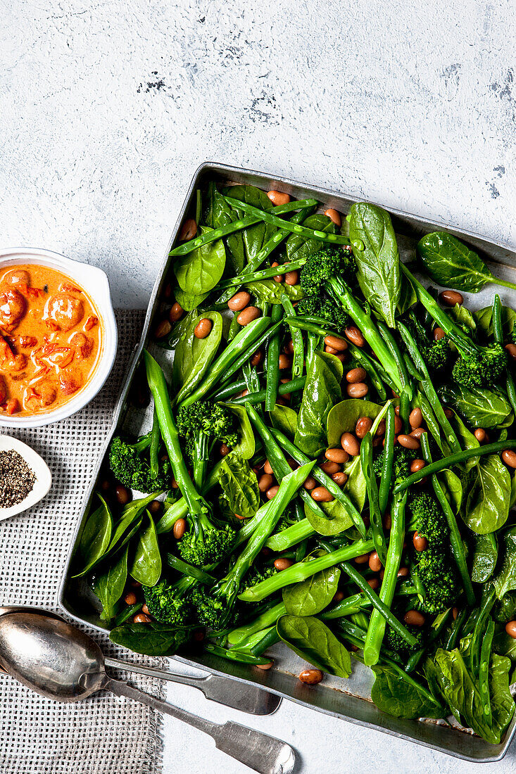 Warm green vegetable salad with spicy tomato dressing