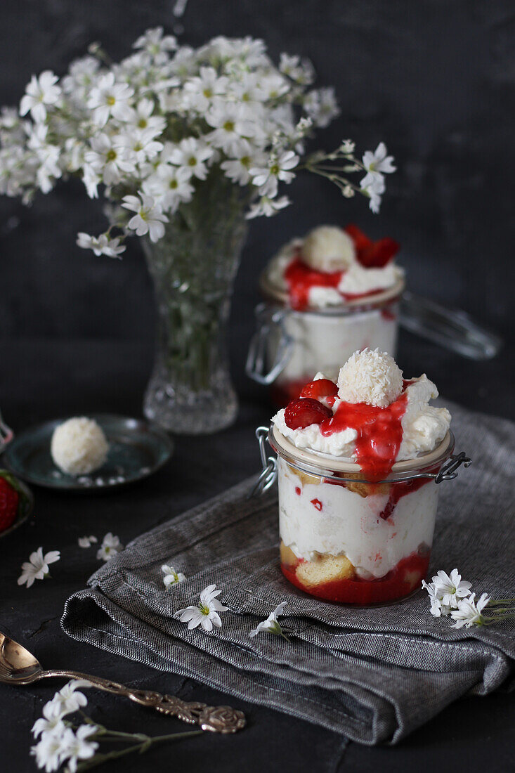 Strawberry tiramisu in a glass with coconut balls