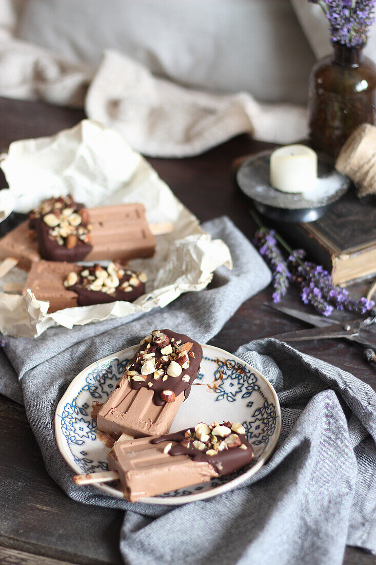 Chocolate ice cream on a stick with nuts and chocolate icing