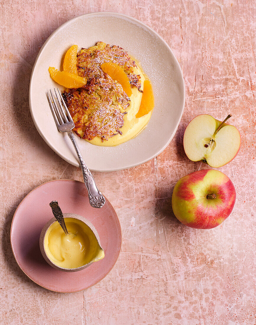 Apple and potato pancakes with orange fillets on a wine foam sauce