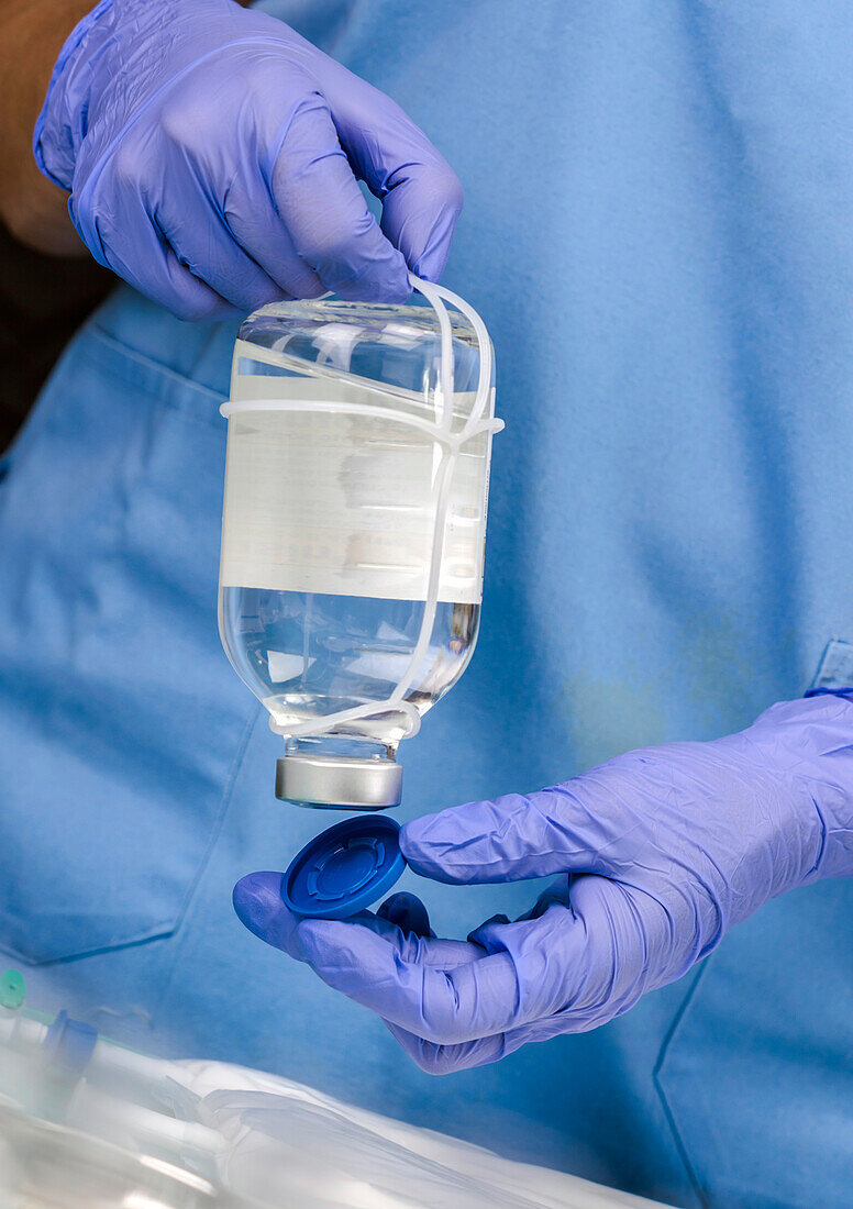 Nurse opening a medicine bottle in a hospital