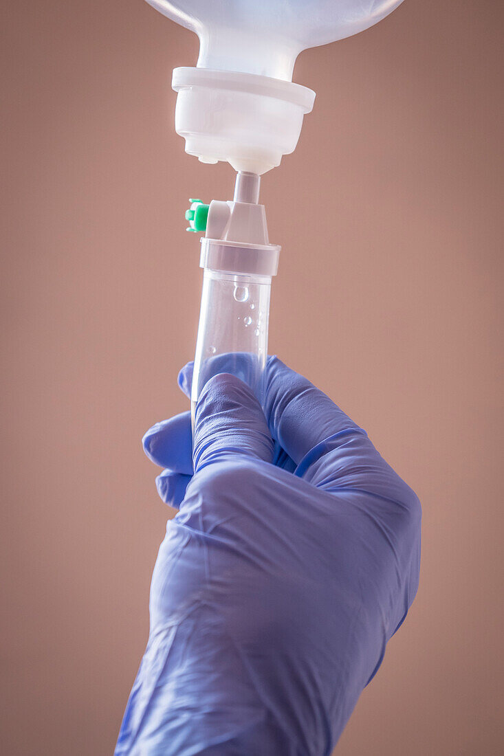 Nurse managing fluid with a dropper