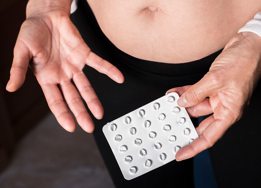 Woman holding an empty blister pack of pills