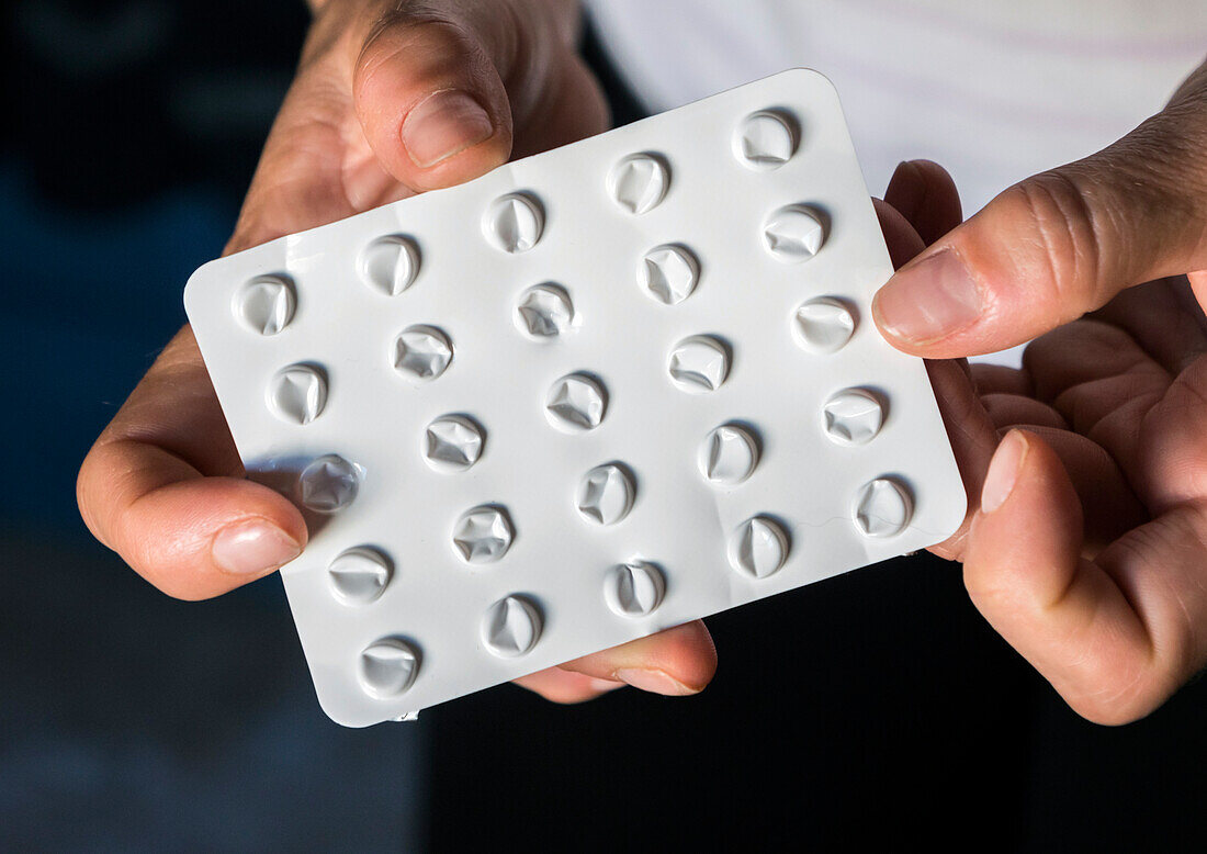 Woman holding an empty blister pack of pills