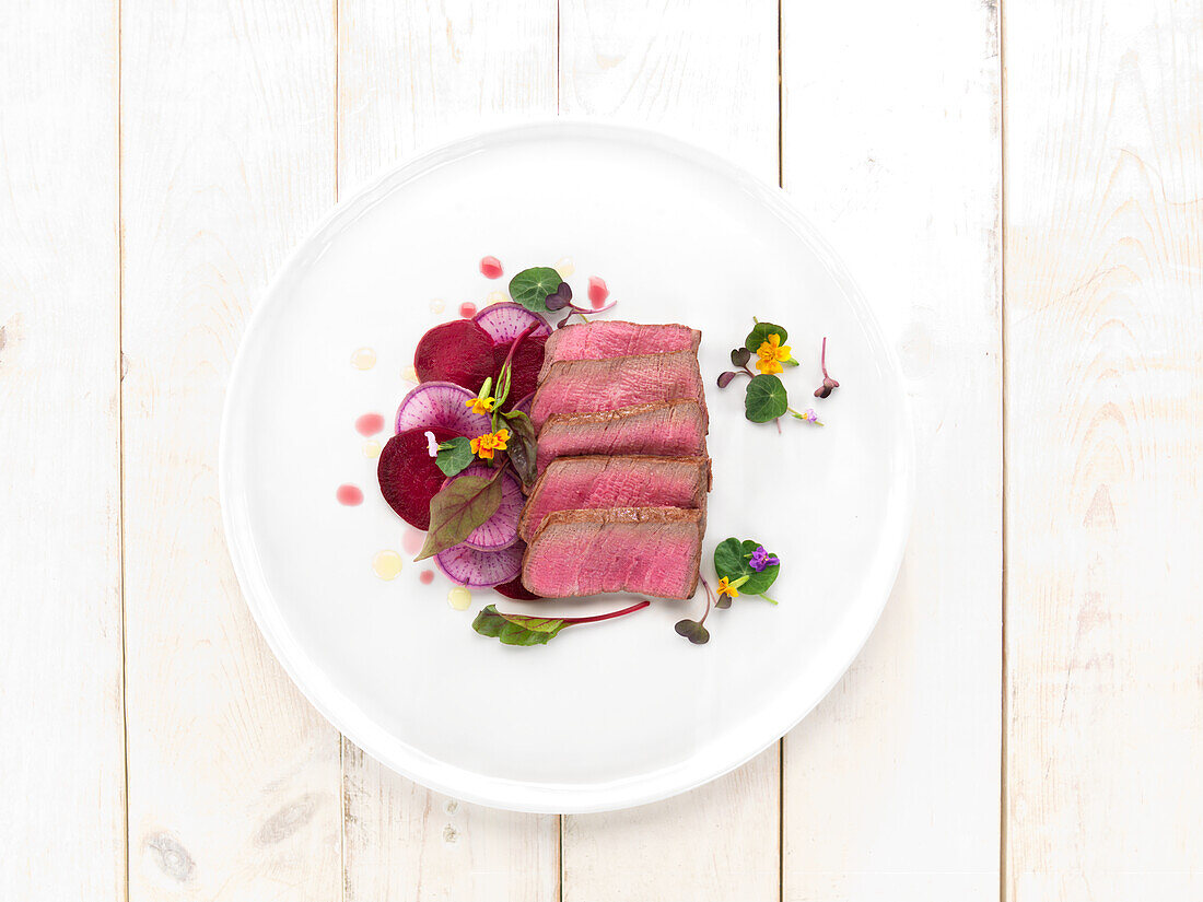 Fried beef with thinly sliced radishes and beets