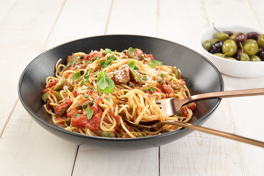 Spaghetti with tomatoes, olives, and capers