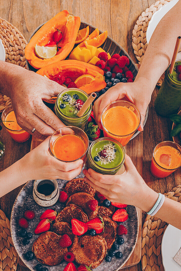 A healthy family breakfast with smoothies and orange-and-carrot juice