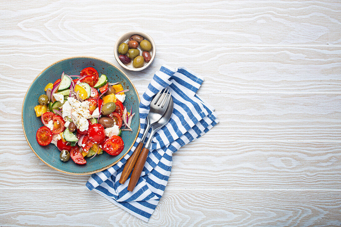 Greek fresh healthy colorful salad with feta cheese, vegetables, olives