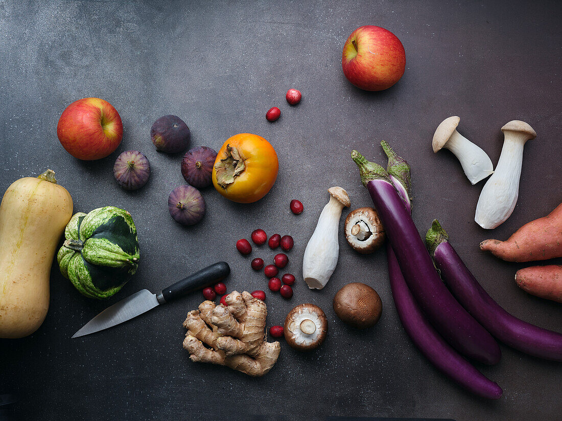 Top view seasonal groceries, healthy vegetarian ingredients on a dark background