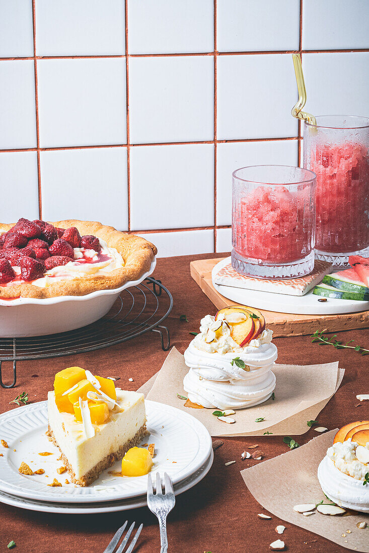 White chocolate cheesecake with mango, meringue nests, and pie with strawberries and mascarpone cheese