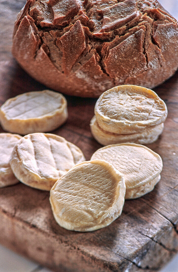Rocamadour cheese (French goat's cheese) and a loaf of bread