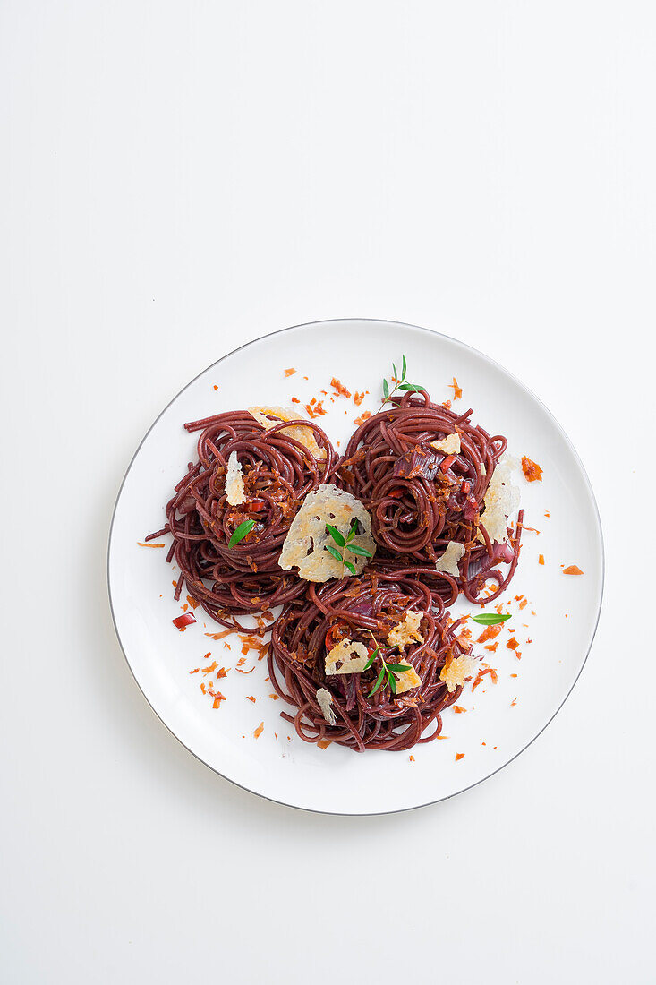 Spaghetti with red wine sauce, pecorino, and prosciutto
