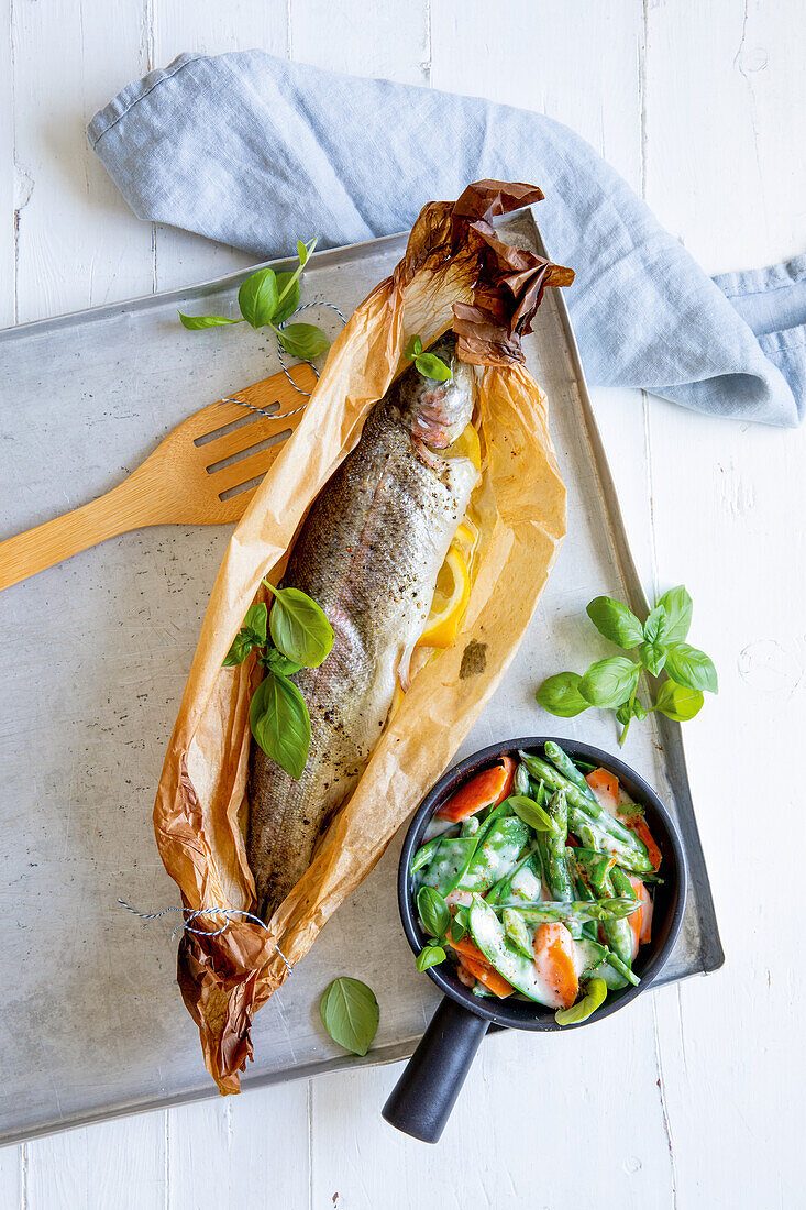 Trout parchment parcels with asparagus vegetables