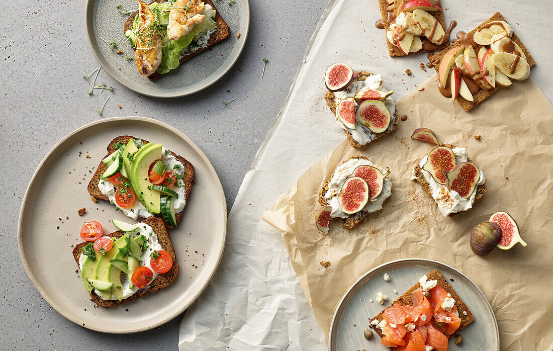 A variety of sandwiches with figs, salmon, chicken, avocado, and banana