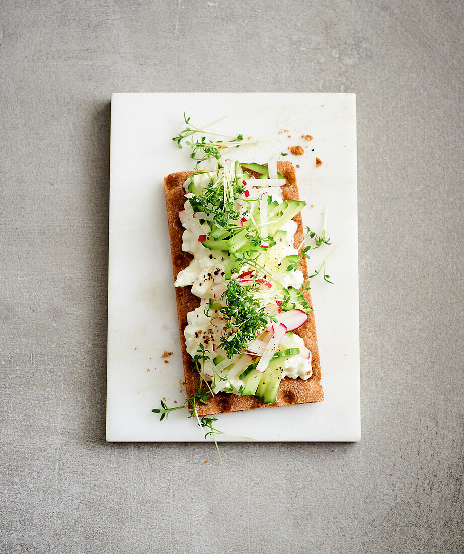 Crispbread with grainy cream cheese, radish, and cress