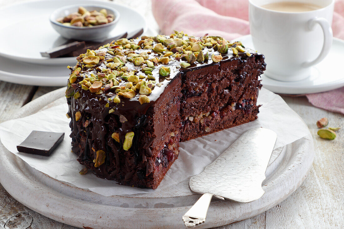 Layered chocolate cake with walnuts, sprinkled with pistachios