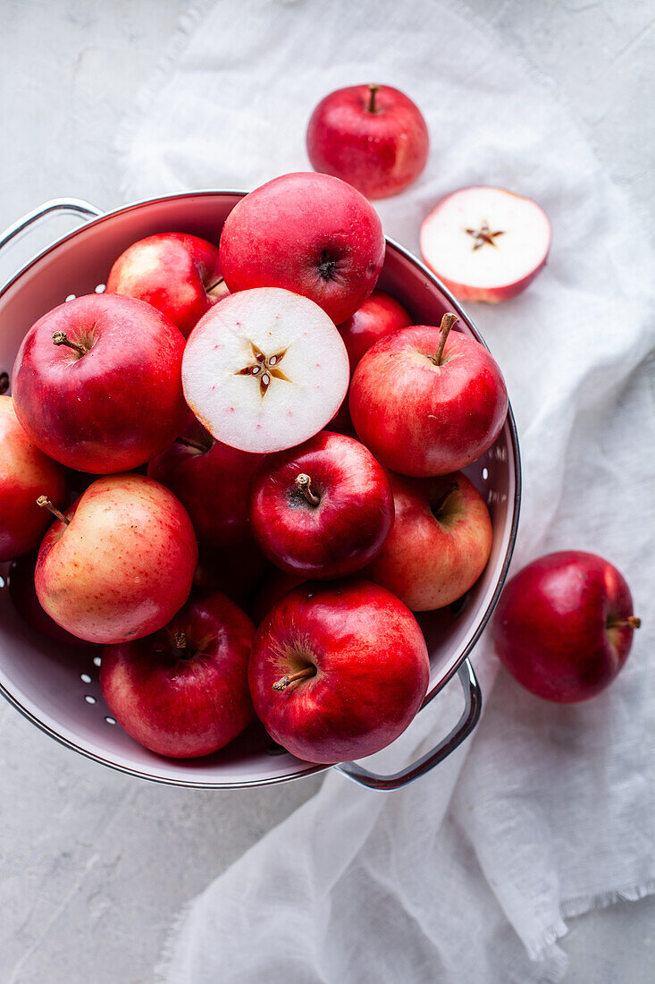 Fresh red apples in a colander