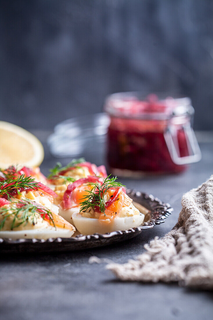 Deviled eggs with salmon, lemon mayonnaise and pickled red onion