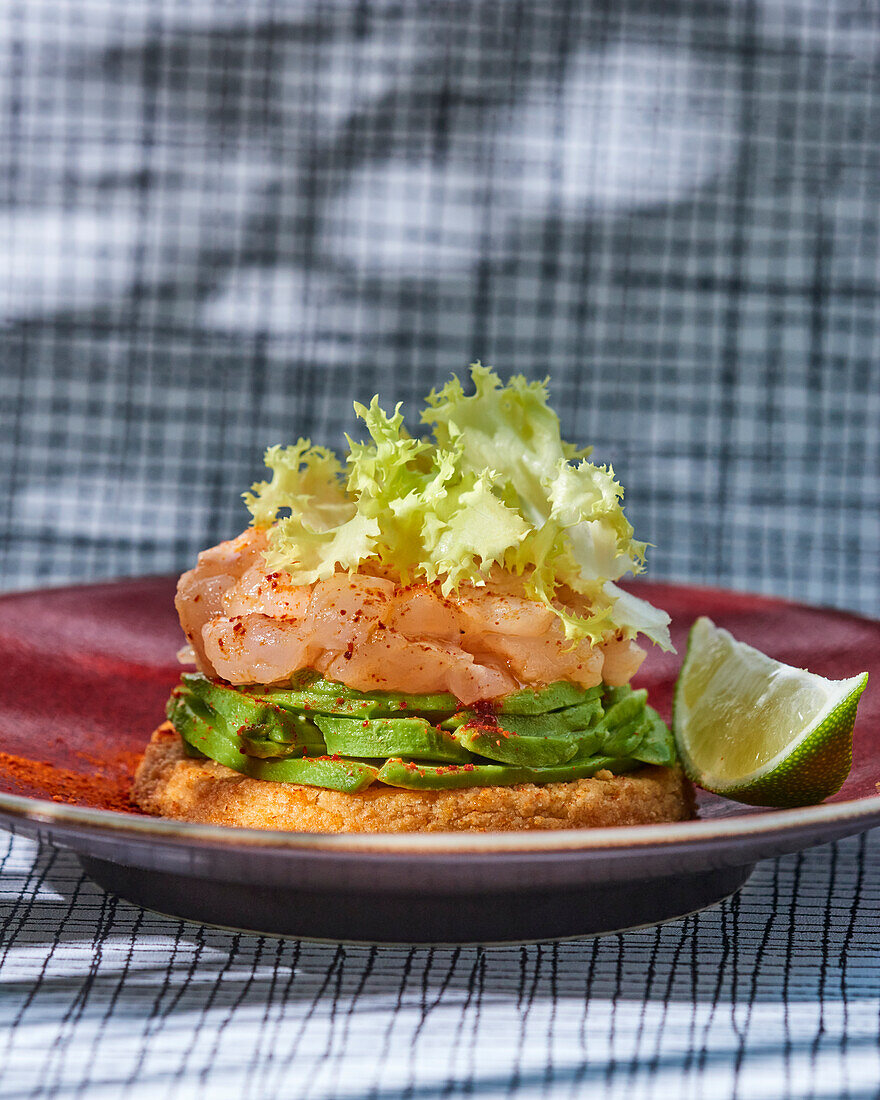 Dorade tartare with avocado on parmesan cakes