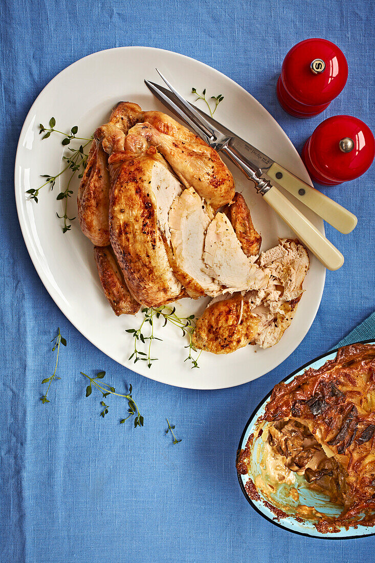 Roasted chicken served with potato gratin with porcini mushrooms and shallots