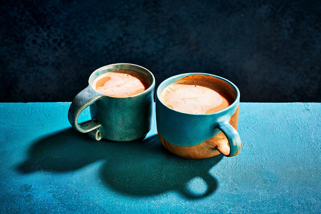 Chai latte in blue ceramic mugs