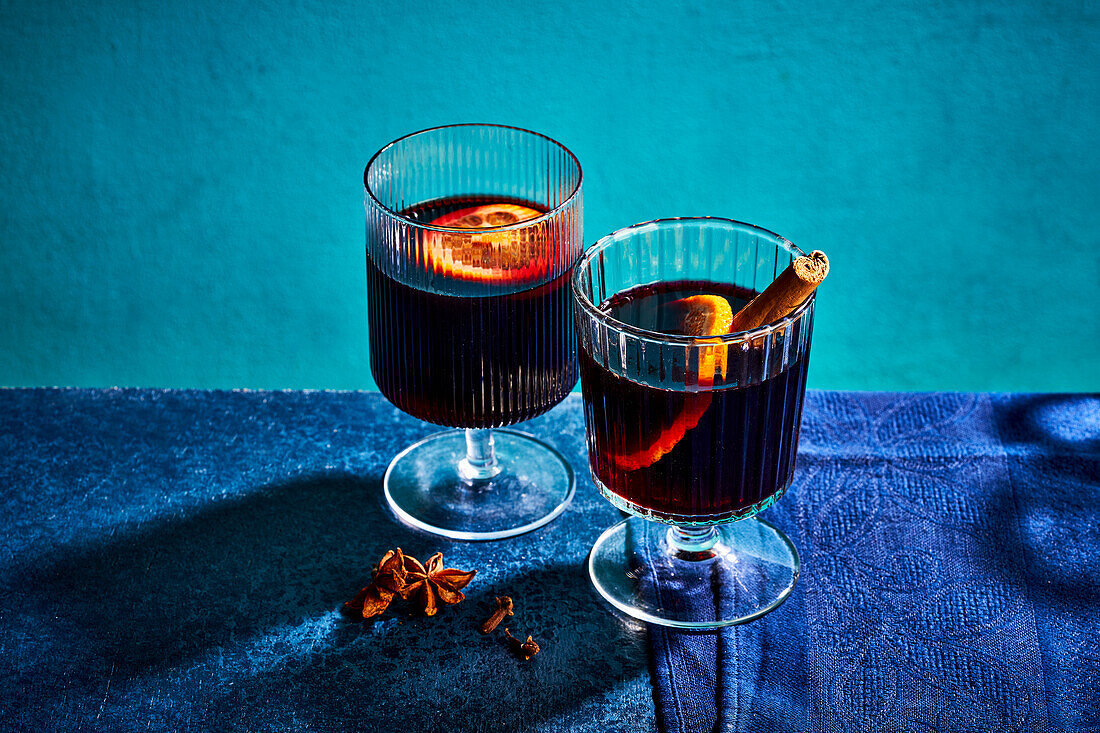 Red mulled wine with an orange slice and a cinnamon stick
