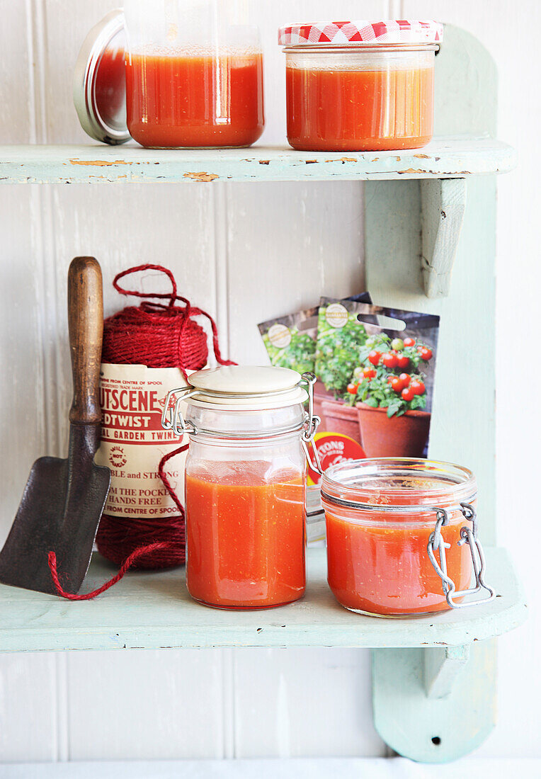 Strained tomatoes in storage jars