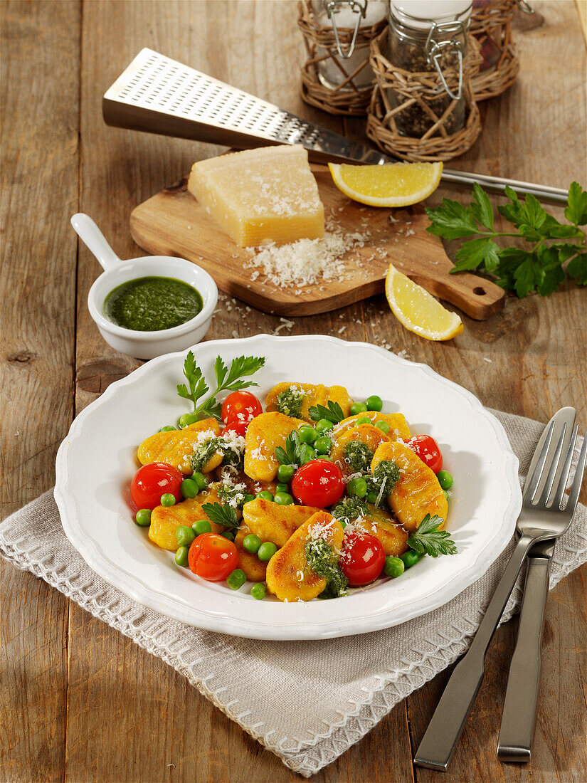 Pumpkin gnocchi with peas, cherry tomatoes, and parsley oil