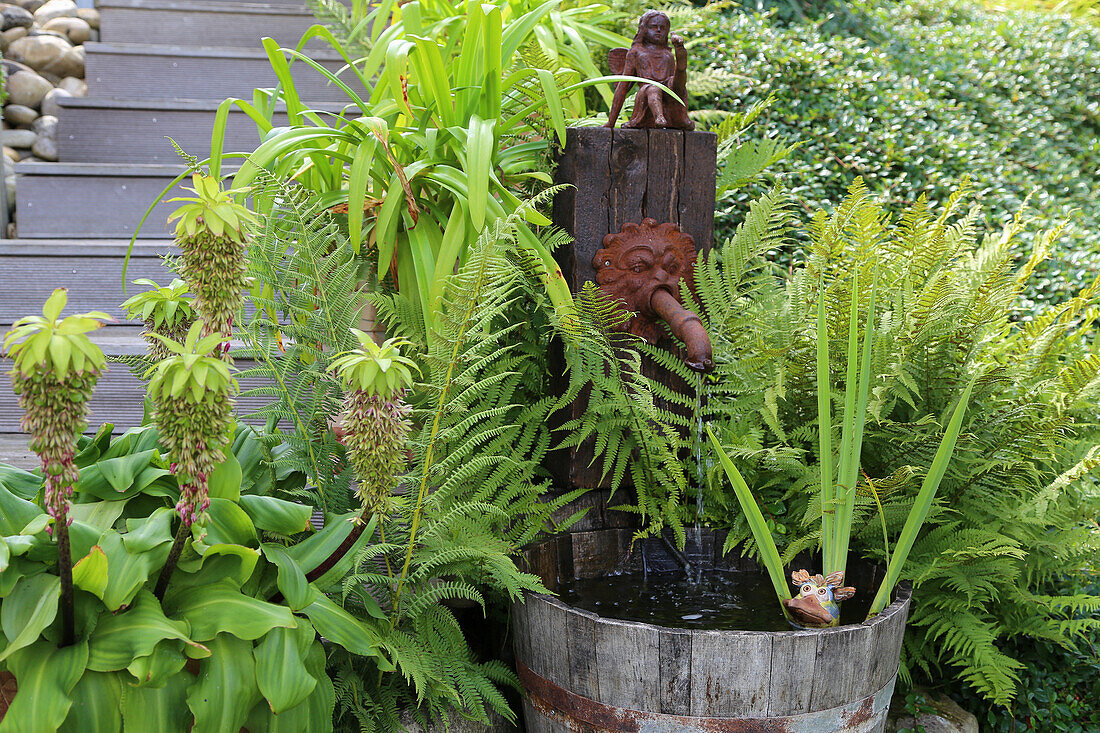 A water pump with ferns and lily pads