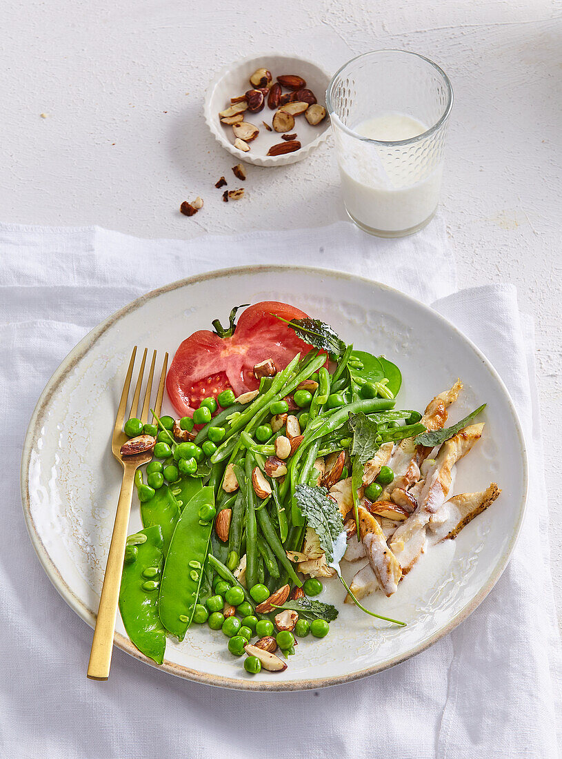 Chicken marinated in yogurt with green beans and peas