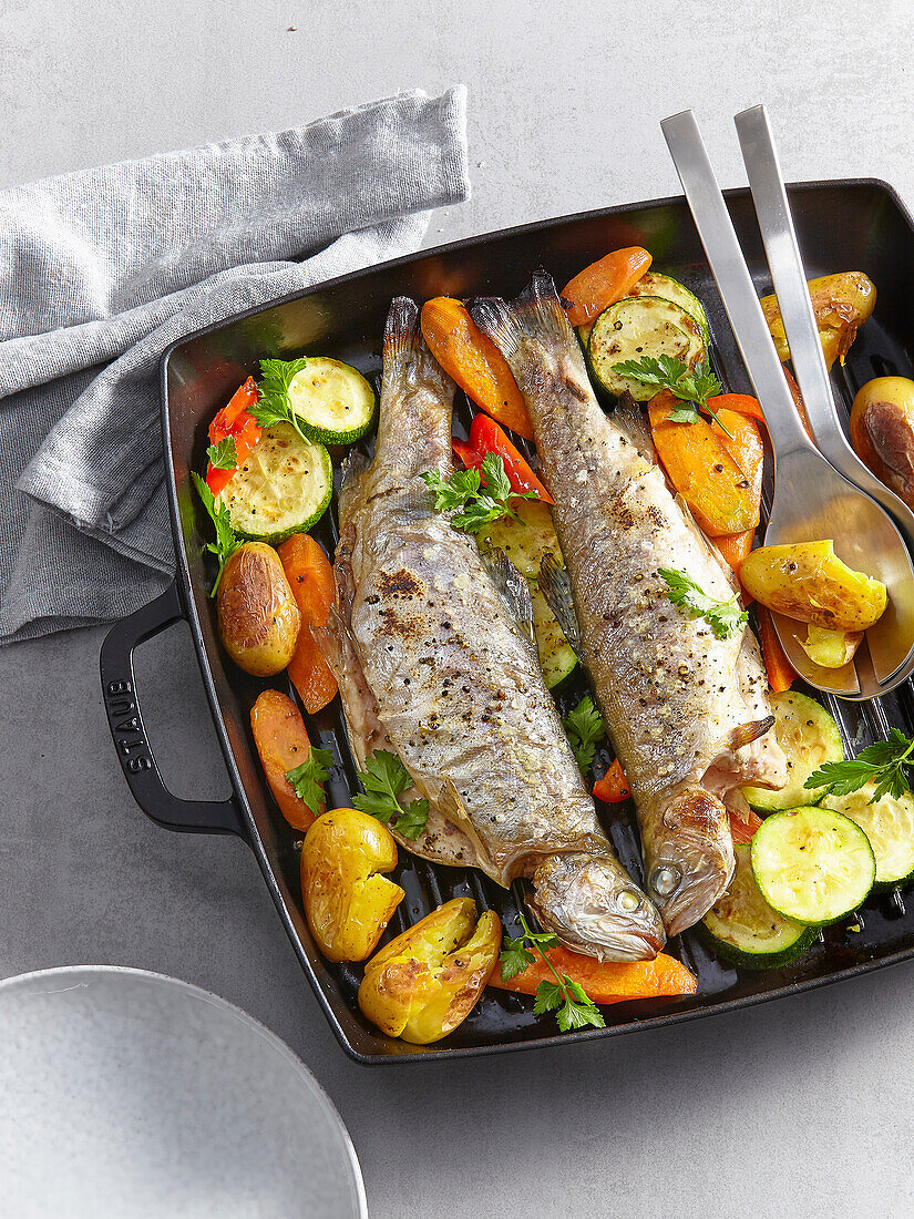Baked trout with potatoes and vegetables