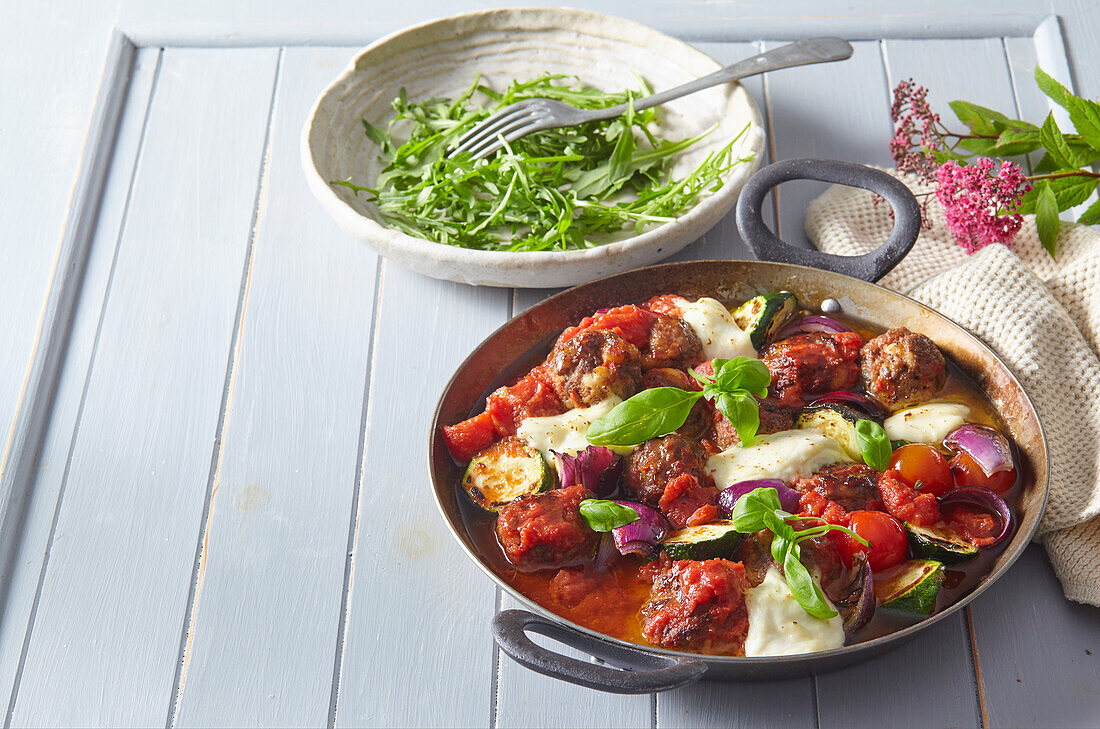 Baked meatballs with vegetables and mozzarella cheese