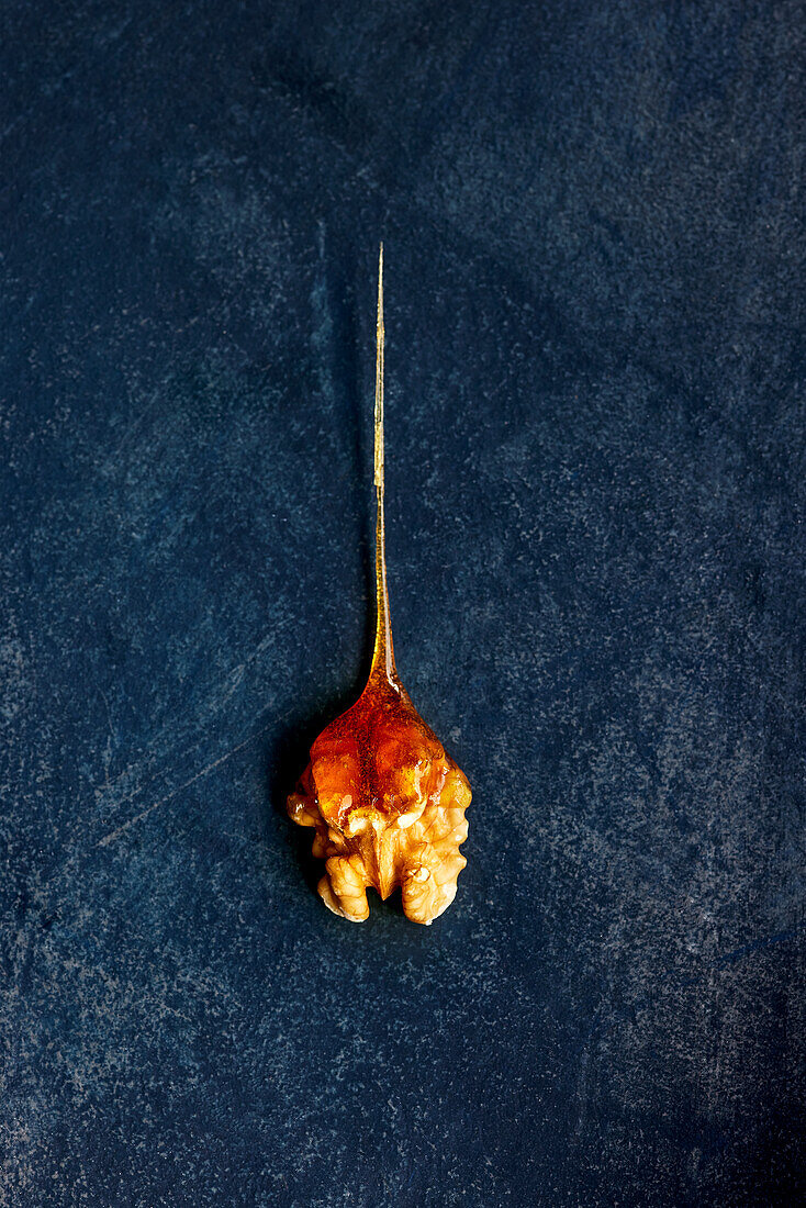 Candied caramel coated walnut on a dark base