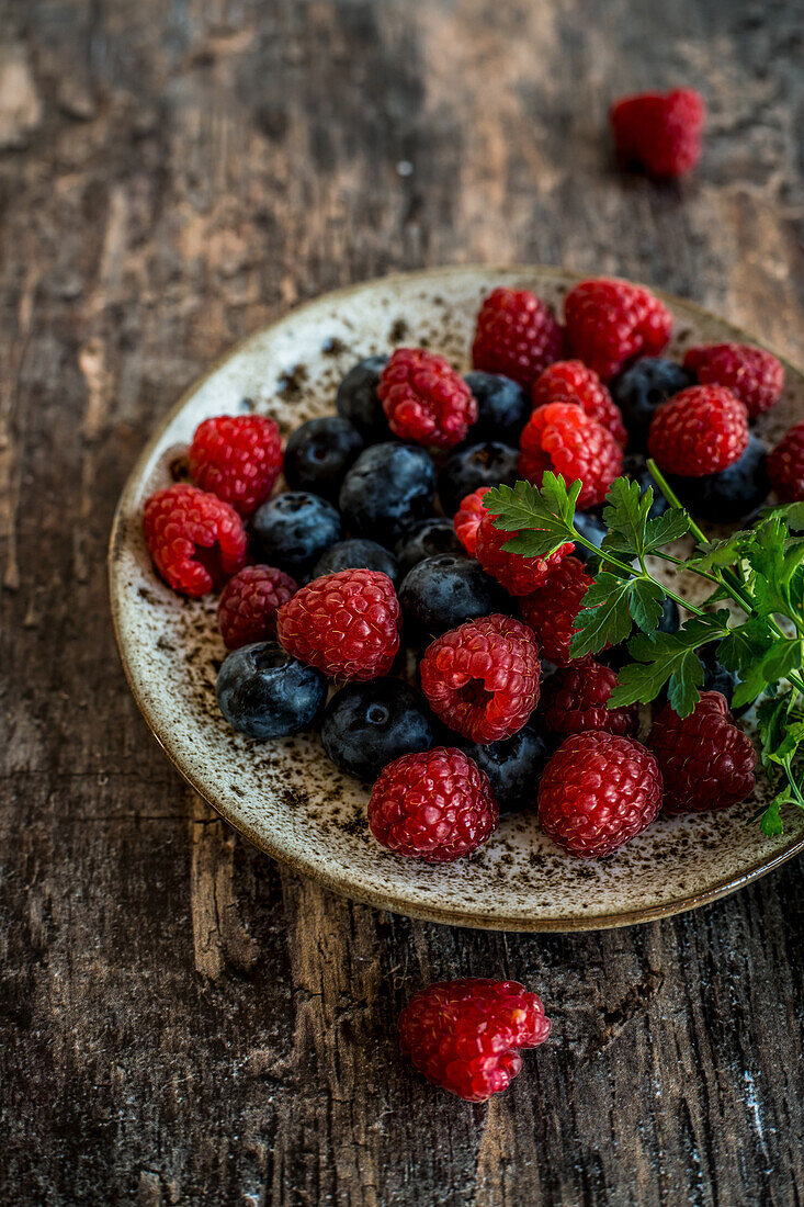 Raspberries and blueberries on a plate