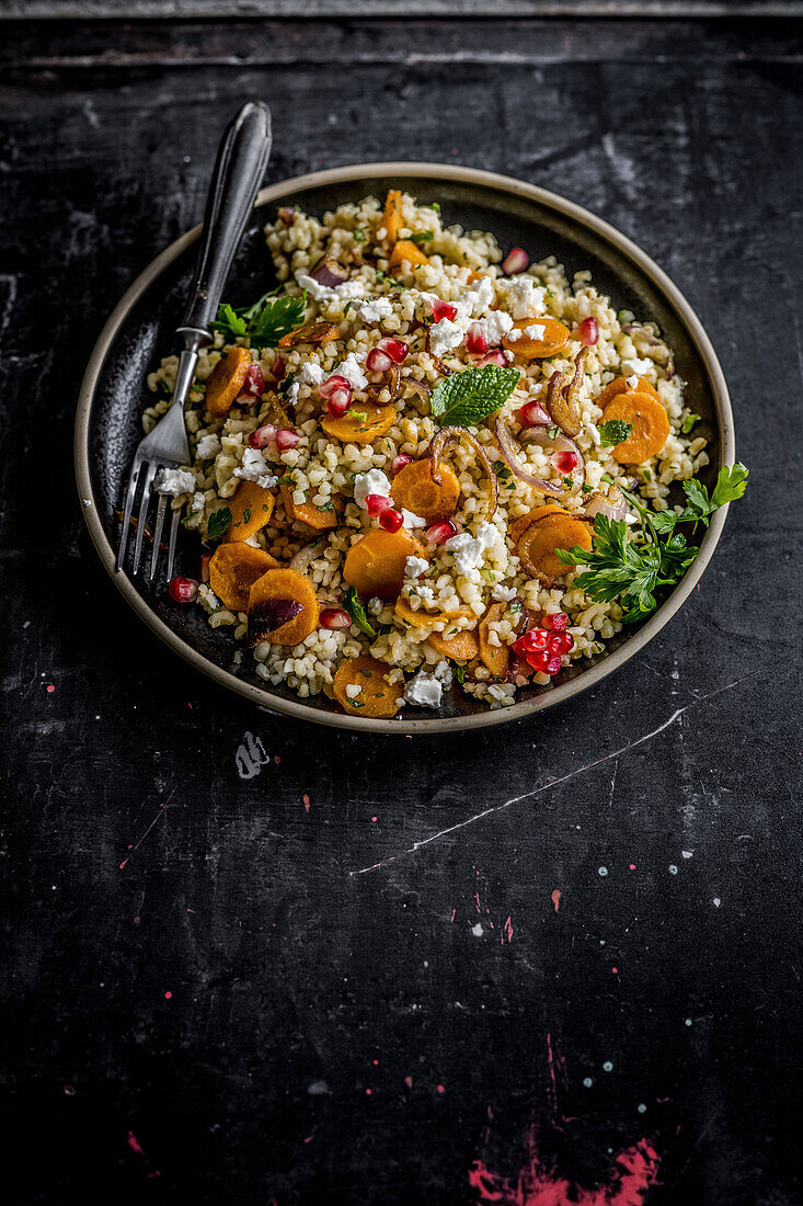 Bulgur porridge with vegetables and pomegranate seeds ‘Moroccan style’