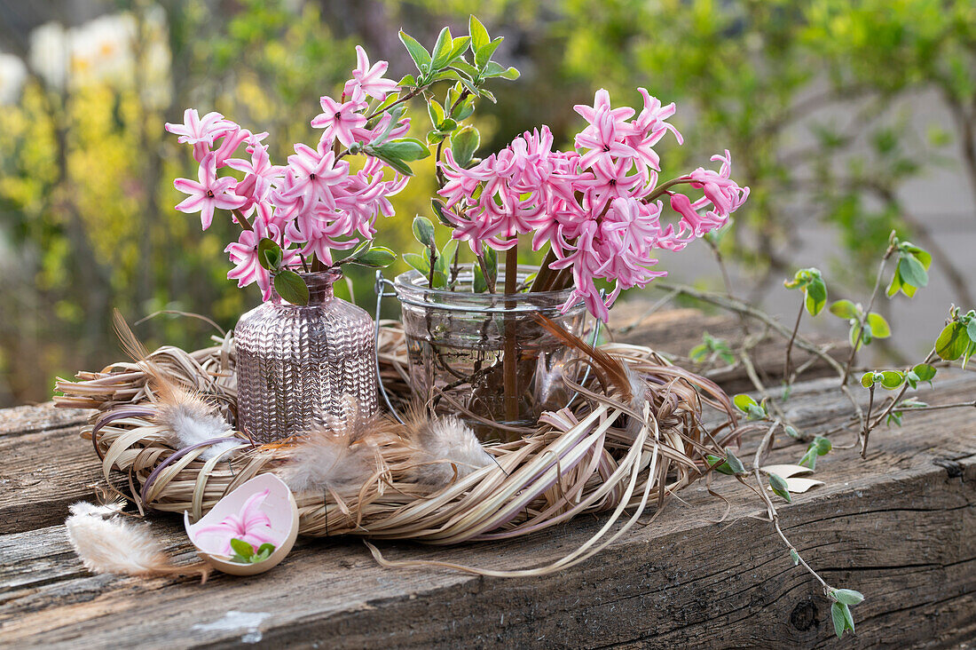 Bouquet of hyacinths in a vase in an Easter wreath with feathers, Easter decoration